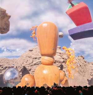 A wooden dummy for anatomy drawing in front of a brown mountainous region. There are surreal elements floating in a cloudy space.