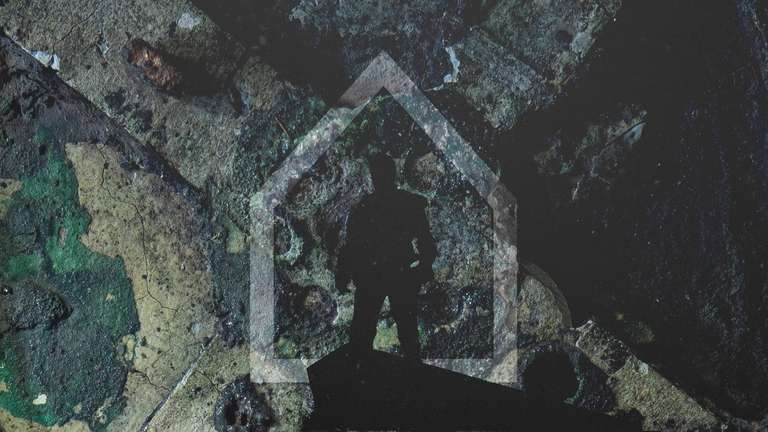 A dark Figure in front of a piktogram of a house.