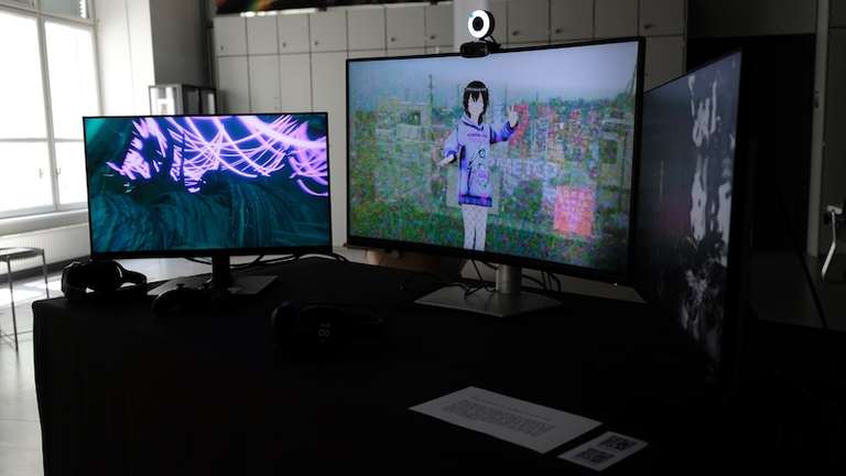 Three screens, each showing three different things: On the very left you have an enviorment which you can explore, in the middle you see an anime-character style girl that follows your movement, and on the right you have a black and white video clip of a figure and different glitches affecting it.